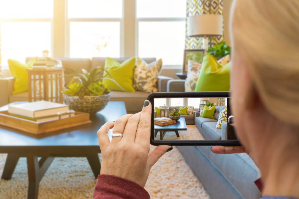 A woman taking a photo of her beautiful living room