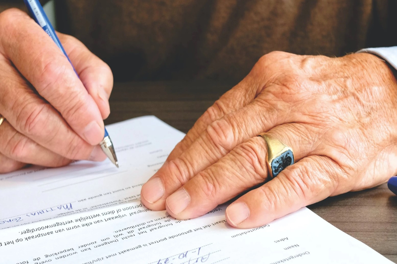 A man signing a paper