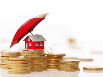 red miniature house on coins