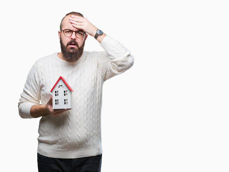 man holding a miniature california house